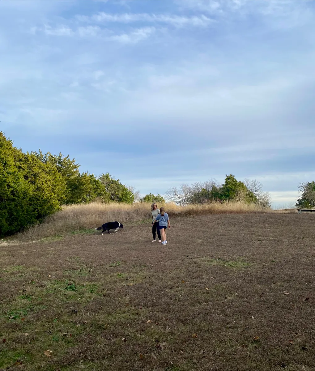 Mother walking outside with her child and dog, representing nervous system healing, longevity, and rebuilding strength after chronic stress.